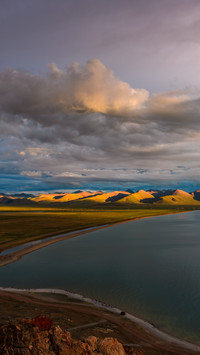 The sunset reflects on the lake's surface.