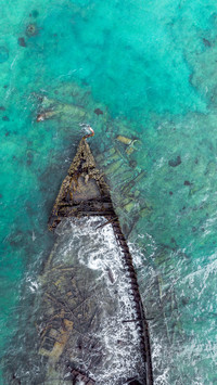 Drone overlooking sunken ship bow