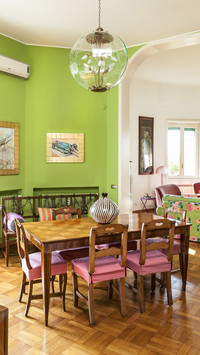 Dining table wooden chairs and green walls in front of