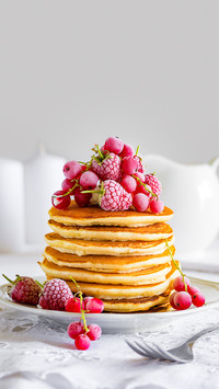 Stack of pancakes with raspberry