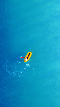 Yellow Packraft Rubber Boat and Turquoise Water Waves
