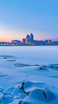 Cold Winter night cityscape with illuminated buildings