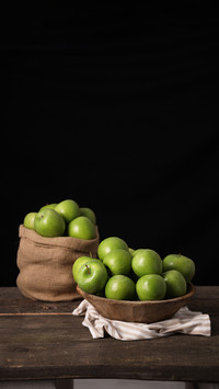 Green Apple on the wooden basket