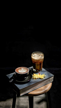 A Cappucino inside a Black Cup