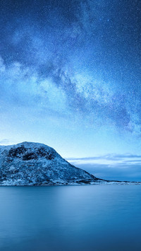 Galaxy above the mountains and the ocean. Landscape at night