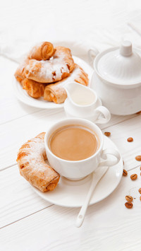 Coffee, orange jam bagels. Breakfast. on wooden table
