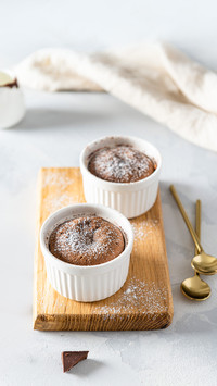 Warm Chocolate Lava Cake with sugar powder in ramenkins