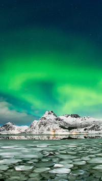 Aurora borealis over frozen lake
