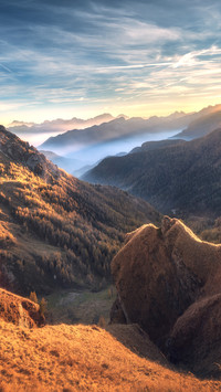 Mountains in fog at beautiful sunset in autumn