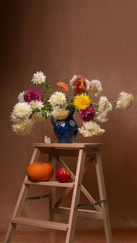 Bouquet of white, orange, red chrysinths in a vase
