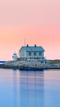 House on peninsula of a swedish coast in evening sunset