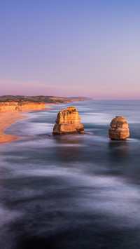 The twelve apostles stand by the coast.