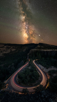 Horseshoe bend road at night with car light streaks