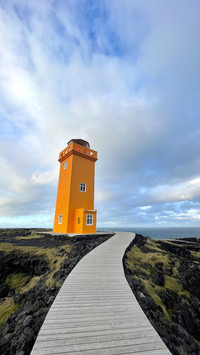 Bright orange lighthouse on cliff