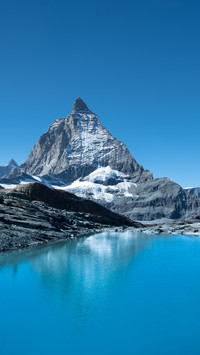 Grand Mountain Embracing Its Blue-Gem Below