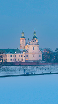 Frozen Vistula riverbank with Pauline fathers church