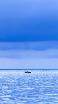 Floating fishing boats aground at the harbor over cloudy sky