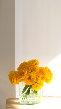 Bouquet of yellow tulips on the wooden table