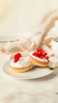 Plate with tasty tartlets and cup of coffee on table