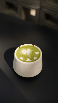 Hot green tea latte with heart and love latte art in a cup