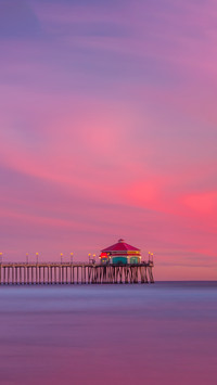 A wide sunset shot of Huntington Beach Pier