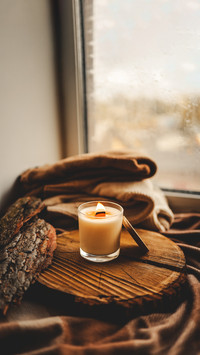 Burning candle in home interior, autumn aesthetics