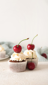 Tasty cherry cupcakes on light background