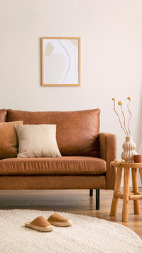 Interior design of stylish and elegant room with brown sofa