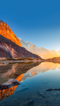 Beautiful landscape with high rocks with illuminated peaks