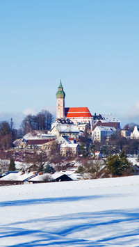 Snowy field and andechs abbey in the distance