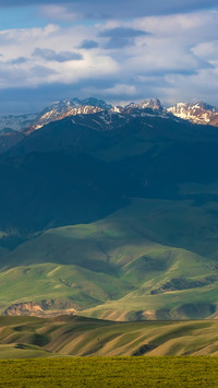 The overlapping clouds and ridges are steep and