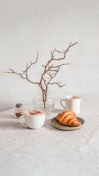 Vase with branches on the table in a bright cozy room