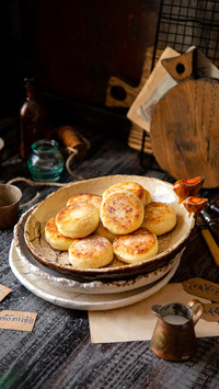 Tasty fried cottage cheese pancakes on ceramic plate