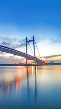 A  bridge on river Hooghly at dusk with city light