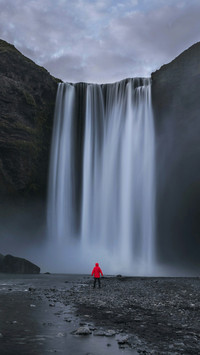 Man Standing Under The Waterfall