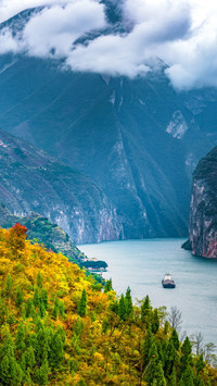 The colorful forests are layered and the clouds surround