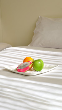 Platter of fresh fruits on the bed