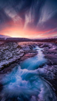 Sunset over the blue river in Iceland