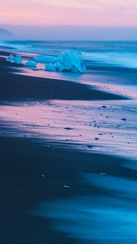 Ice lying on black volcanic beach. Iceland