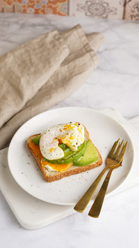 A toast bread with cream cheese on a white plate