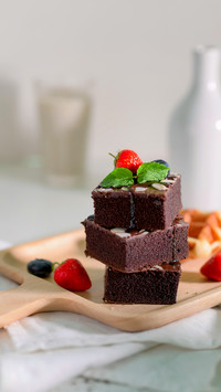 Cropped shot of chocolate brownies with mint leaf