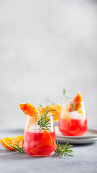 Cocktail with red oranges, rosemary and ice
