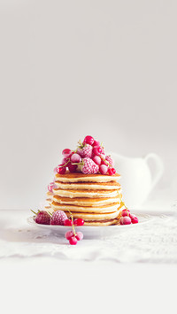 Stack of pancakes with raspberry