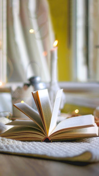 Open book and lit candles