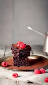 Brownies with fresh raspberry on a metal plate
