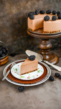 A piece of chocolate mousse cake with blackberries