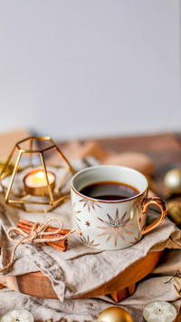 Coffee in a mug with stars on a wooden background