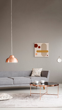 Cups on a shiny, copper golden coffee table in living room