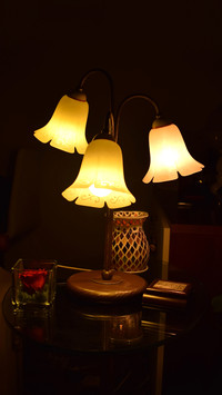 Lamp lit on a glass table. Home sweet home