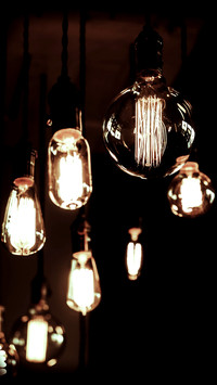 Decorative antique filament light bulbs against brick wall